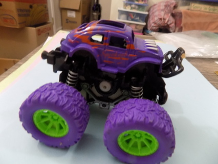 Purple Monster truck on big purple & green tires on springs 5 1/2 long & 3 1/2 tall 