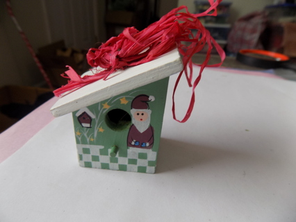 2 inch green wood birdhouse ornament slanted roof and Santa painted on it