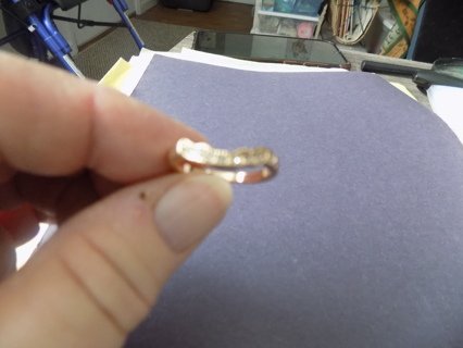 Goldtone thin band ring with wavy line on top covered in rhinestones size 7
