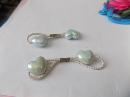 Pair of mint green irredescent heart shape pony tail holders