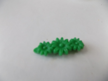 1 1/2 inch green barrette with 3 daisies on it