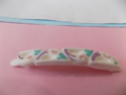 2 1/2 inch white barrette with pastel colors on them