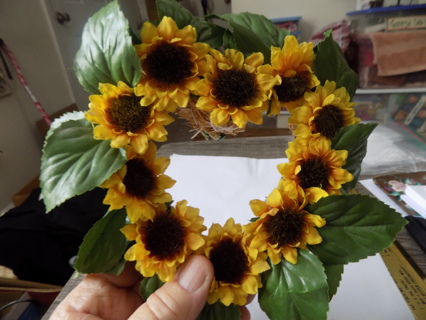 6 inch tall and wide straw heart wreath coverd in sunflowers & green silk leaves