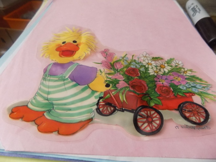 7 inch duckling in green stripe & purple shirt pulling wagon of flowers window cling