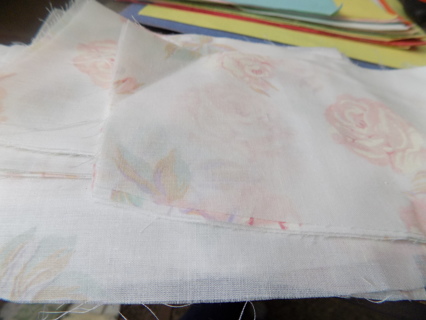 white rectangle material remnant has lt pink roses on it for quilting