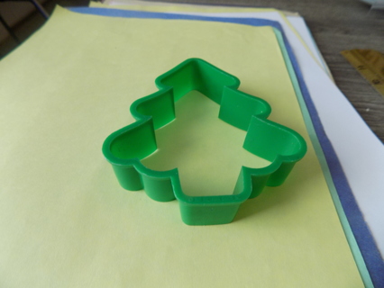 Green plastic Christmas tree shaped cookie cutter