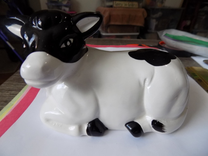 7 inch wide black and white cow lying down ceramic