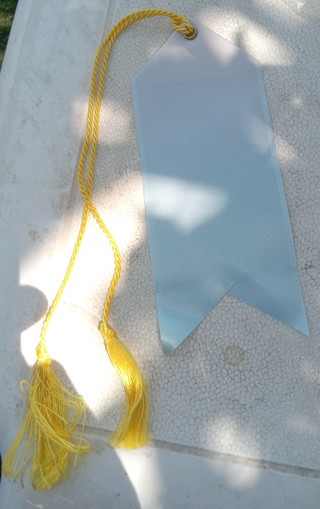 Light blue ribbon with gold or yellow color cord or string