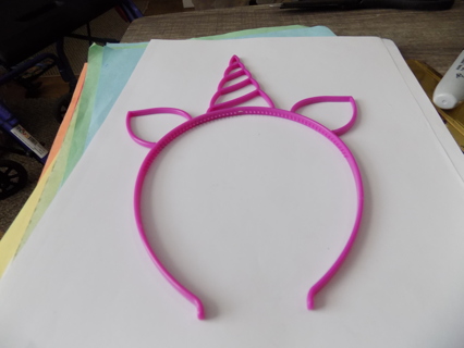 Pink plastic unicorn horn head band
