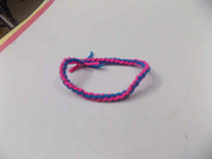 Adjustable hot pink & blue woven thread bracelet on stretchy cord