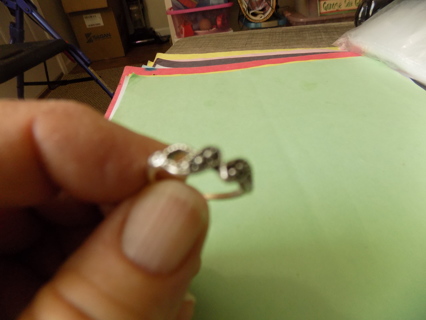 Ring size 4 silvertone  2 adjoining teardrop shape in metal dots inside them