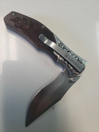 Smith and Wesson Locking pocket knife  with wooden handle.