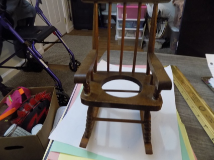 8 1/2 inch tall wooden rocking chair has hole in middle to hold flower pot or glass candle 