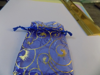 Navy blue drawstring jewelry bag trimmed in gold swirls