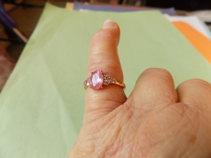 Ring size 6 rose gold with pink faceted jewel and clear ones on the sides