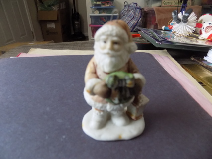 Vintage 3 inch pastel bisque porcelain Santa ornament holds wreath, lantern on ground