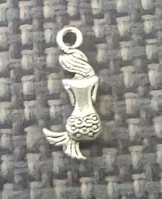 3/4 inch silver tone mermaid charm. Use the get it now option and get a free surprise.