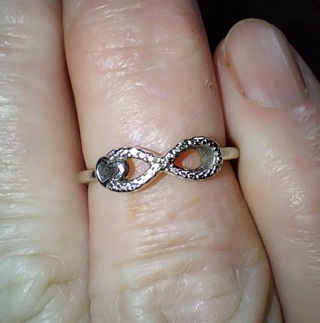 RING SOLID 10K WHITE GOLD WEIGHT 2 GRAMS RING IS SET WITH 4 LITTLE DIAMONDS WHAT A STEAL LOOK!