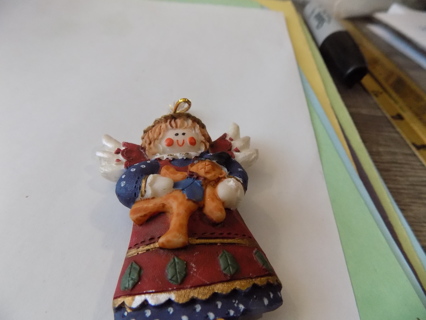 3 inch resin angel ornament holds gingerbread boy dressed in  blue & red gown