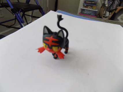 Pokemon black and orange cat character orange whiskers and marks on head