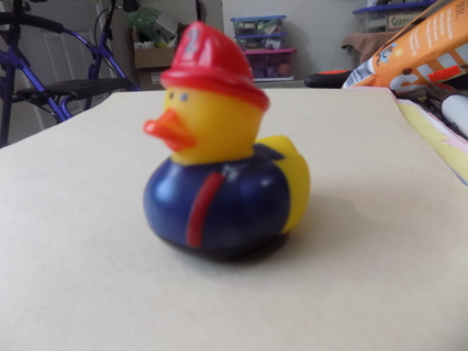 rubber duckie firefighter in blue shirt, red hat