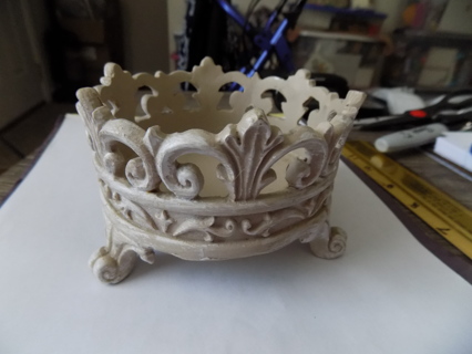 4 1/2 inch round and 3 inch tall off white resin crown shape footed candle holder
