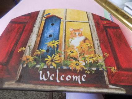 Arched acrylic cutting board 8 1/2 x 7, has yellow cat, black eye Susans in planter box, birdhouse
