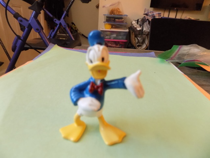 Donald Duck 2 1/ 2 tall his left arm extended