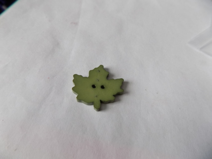 Large green plastic maple leaf button