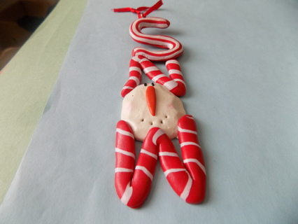 Small polymar clay ornament S N O W spelled out in peppermint stripes